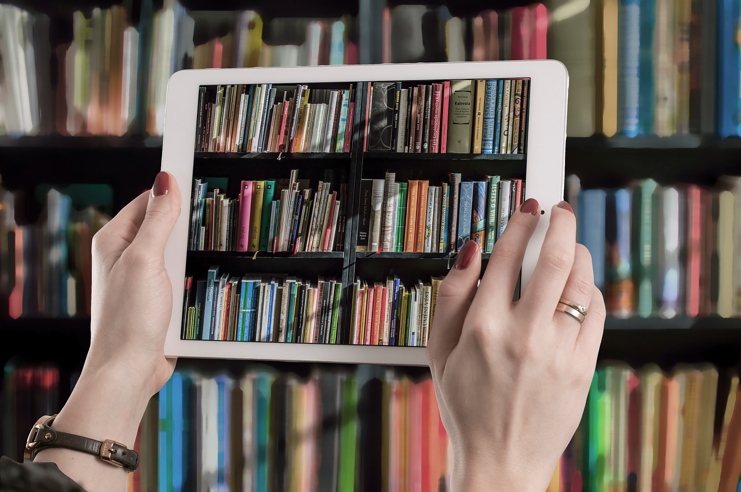 woman hand taking picture of books with an ipad