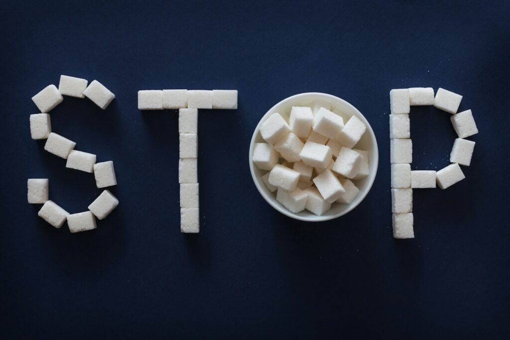 the word stop spelled out of sugar cubes in a bowl.